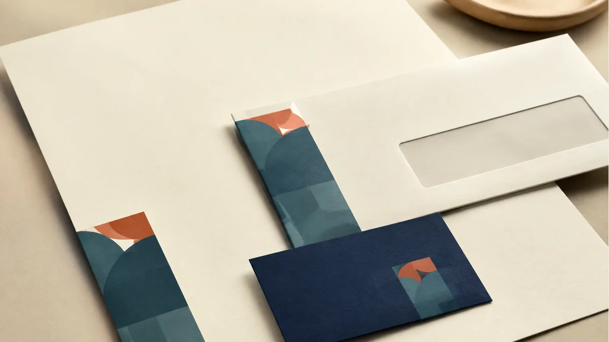 Illustration: Letterhead, window envelope, and business card sharing a geometric motif